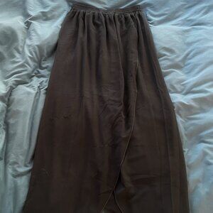 Dark green pants with a cape on top